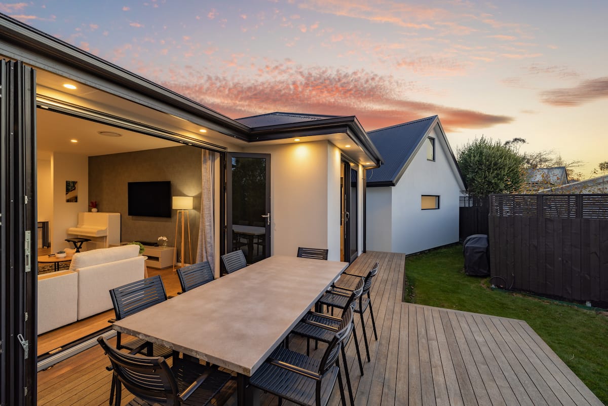 Architectural retreat at twilight, deck and lawn